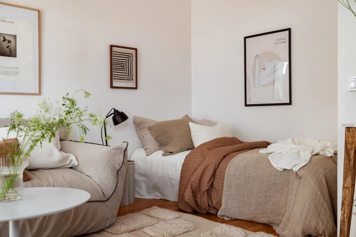 Cozy sleeping area with posters in Swedish apartment