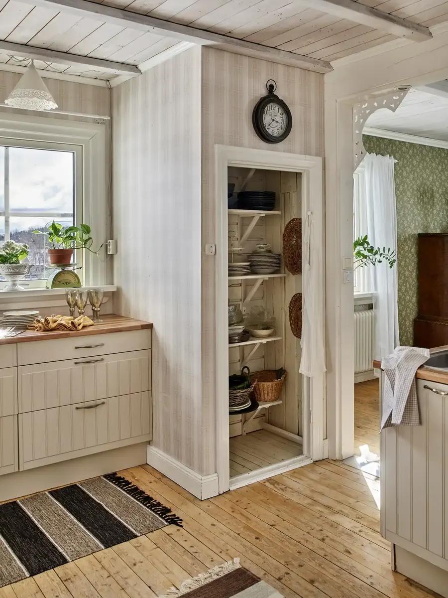 A cozy pantry cupboard filled with jars and kitchen essentials.