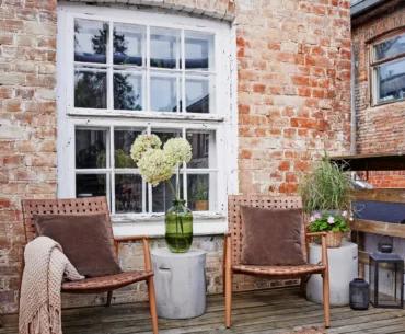 Wicker chairs on a brick house terrace