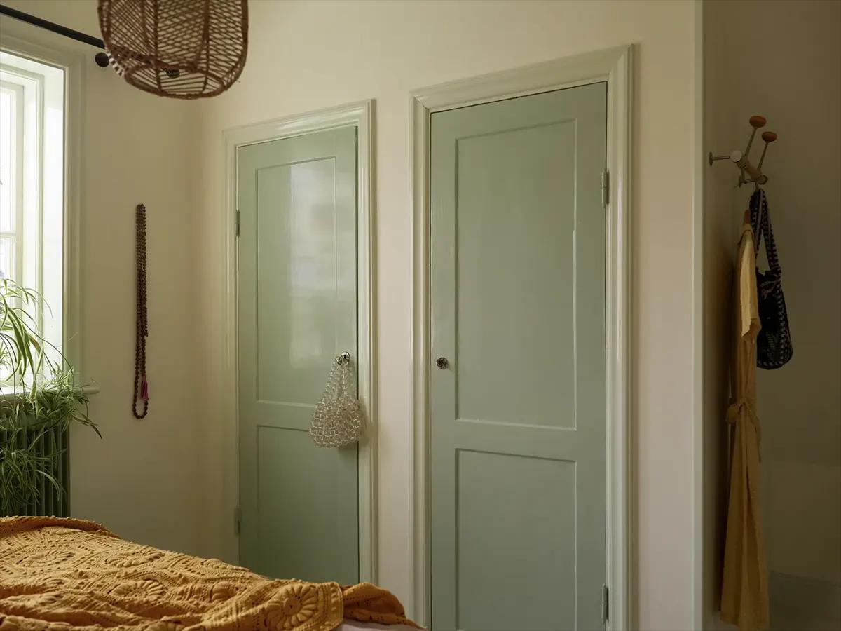 Built-in closets with light green doors