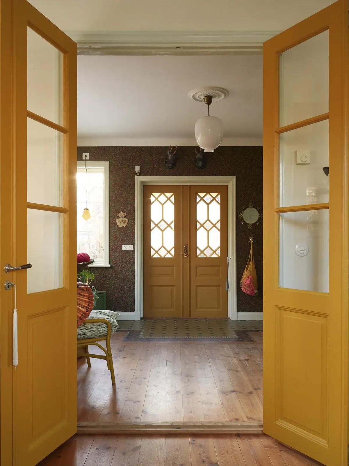 Entryway with bright yellow doors