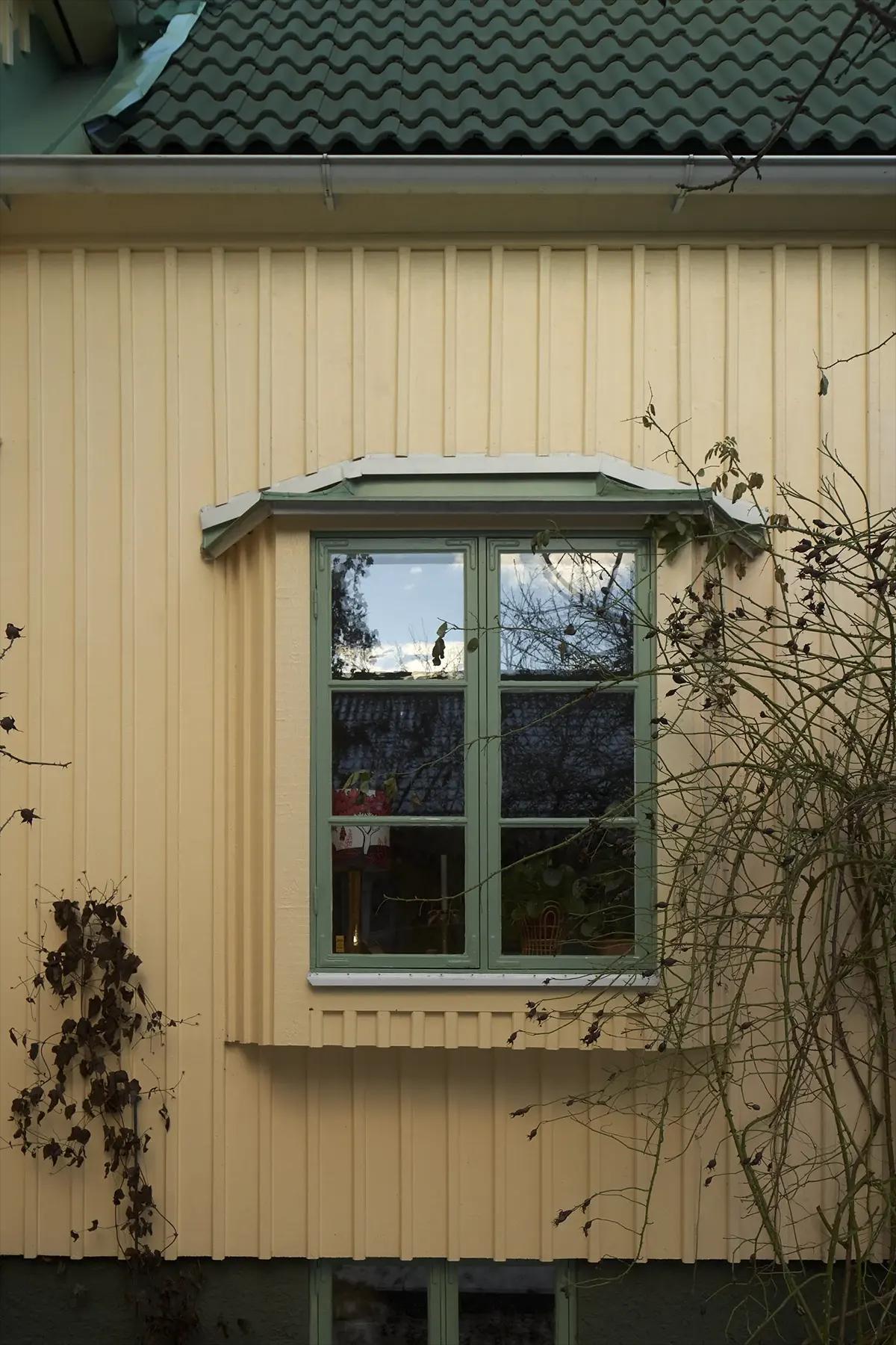 Restored green window frames in the Swedish home
