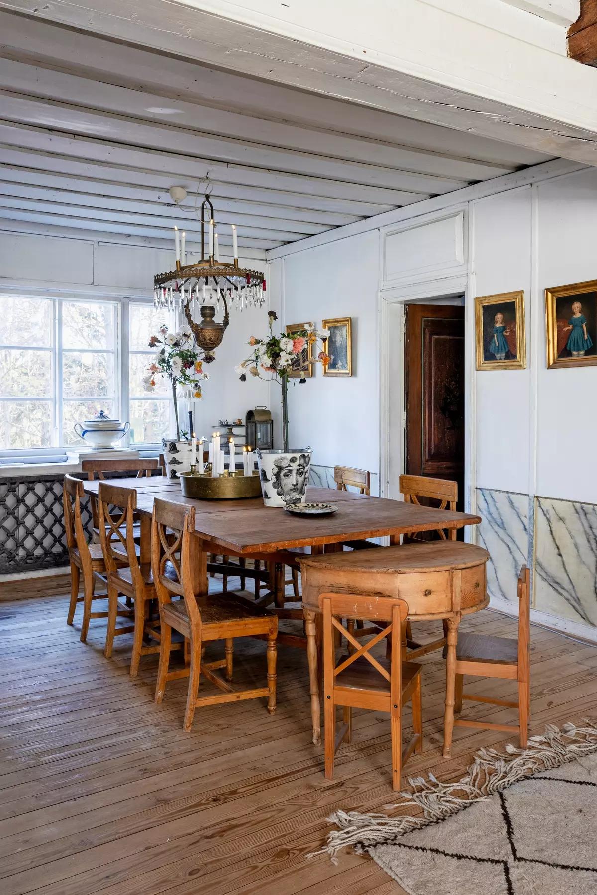 Finnish dining room with large wooden table and antique chairs