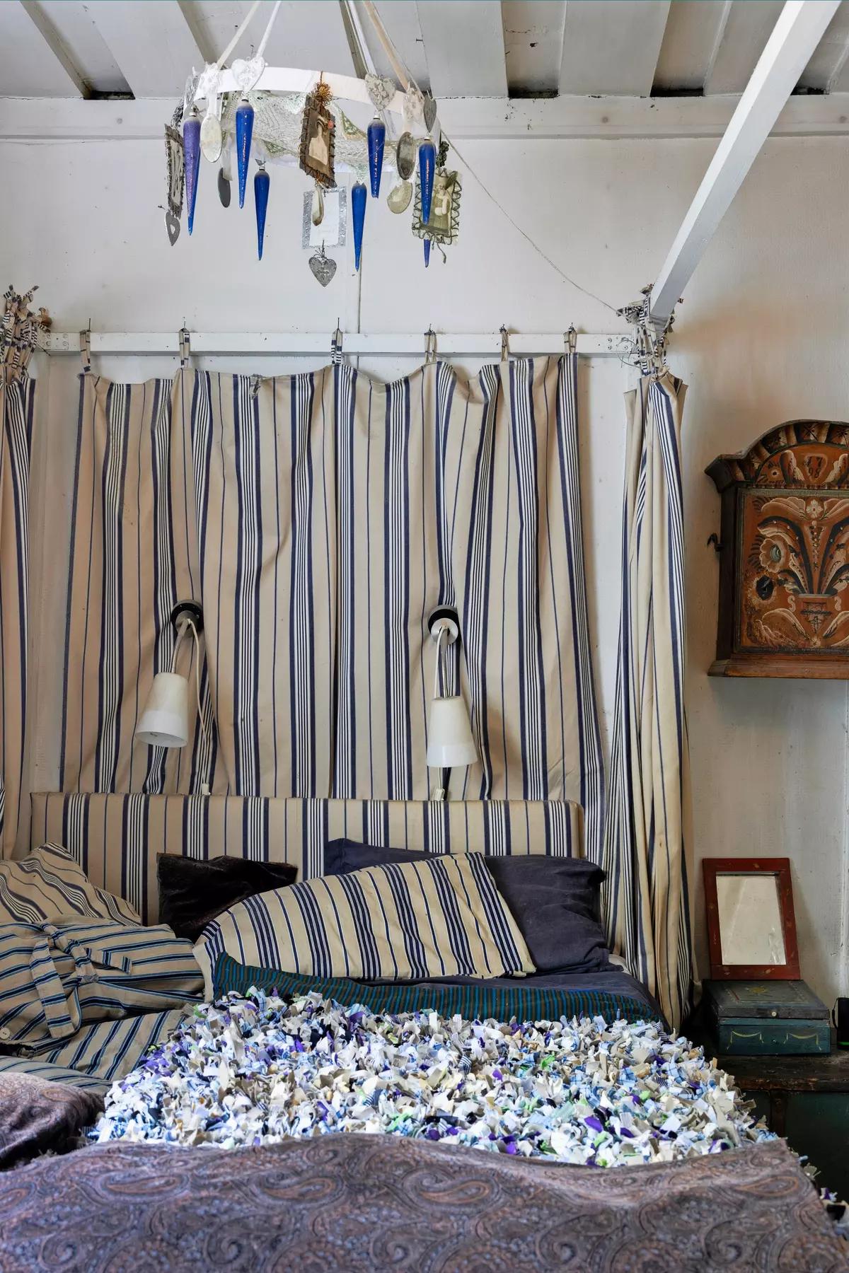 Wall-mounted lights above the bed in a cozy Finnish bedroom