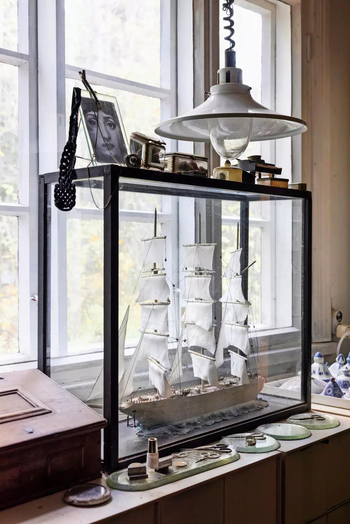Model sailing ship in a glass case on the bedroom shelf