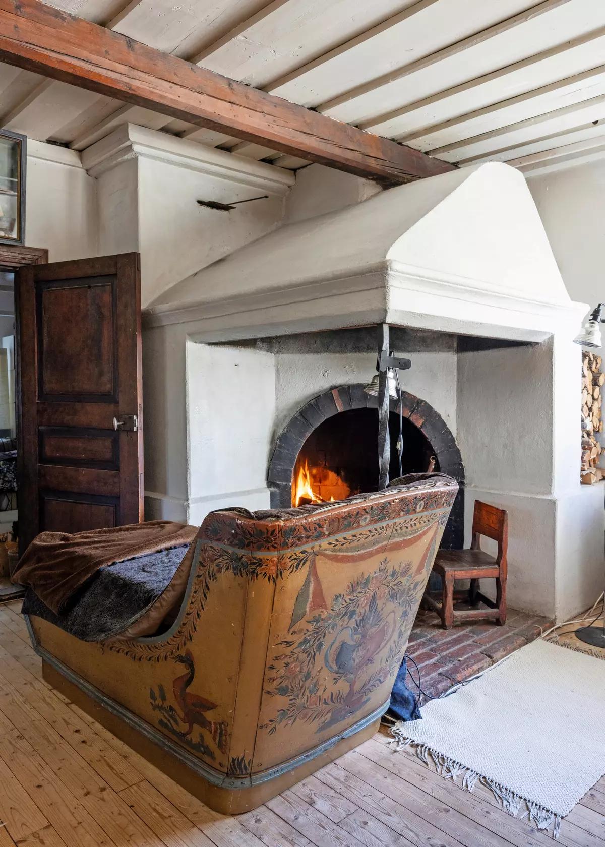 Traditional Finnish stove and handmade sledge chair in the living room
