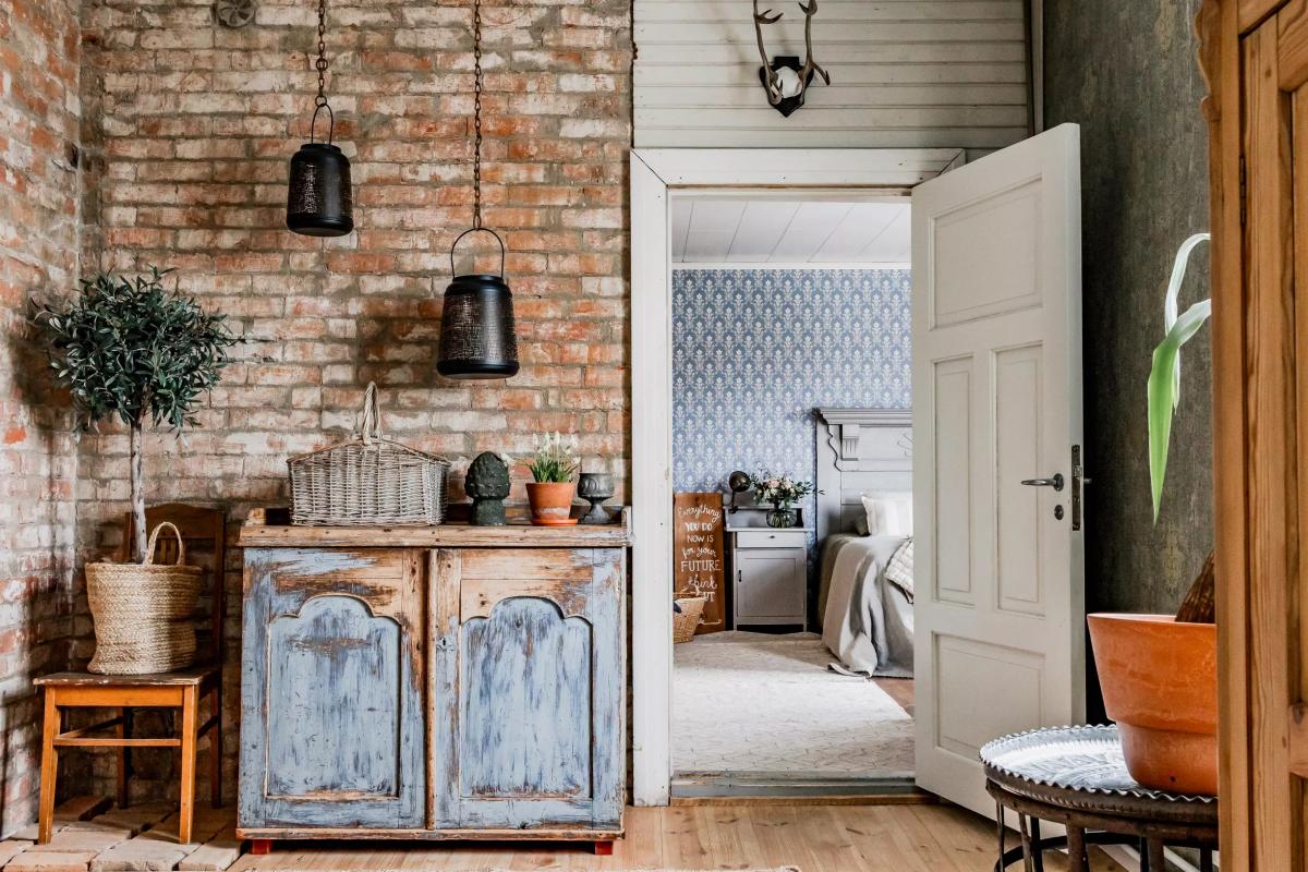 Aged sideboard and exposed brick in Scandinavian interior