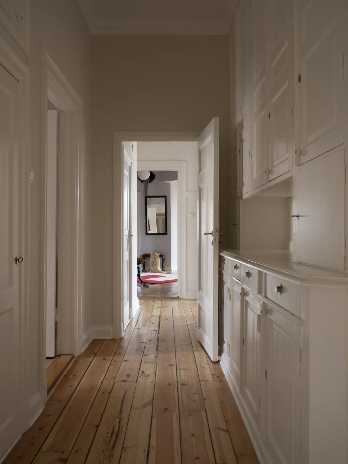 Long hallway with white walls in 19th-century Stockholm apartment