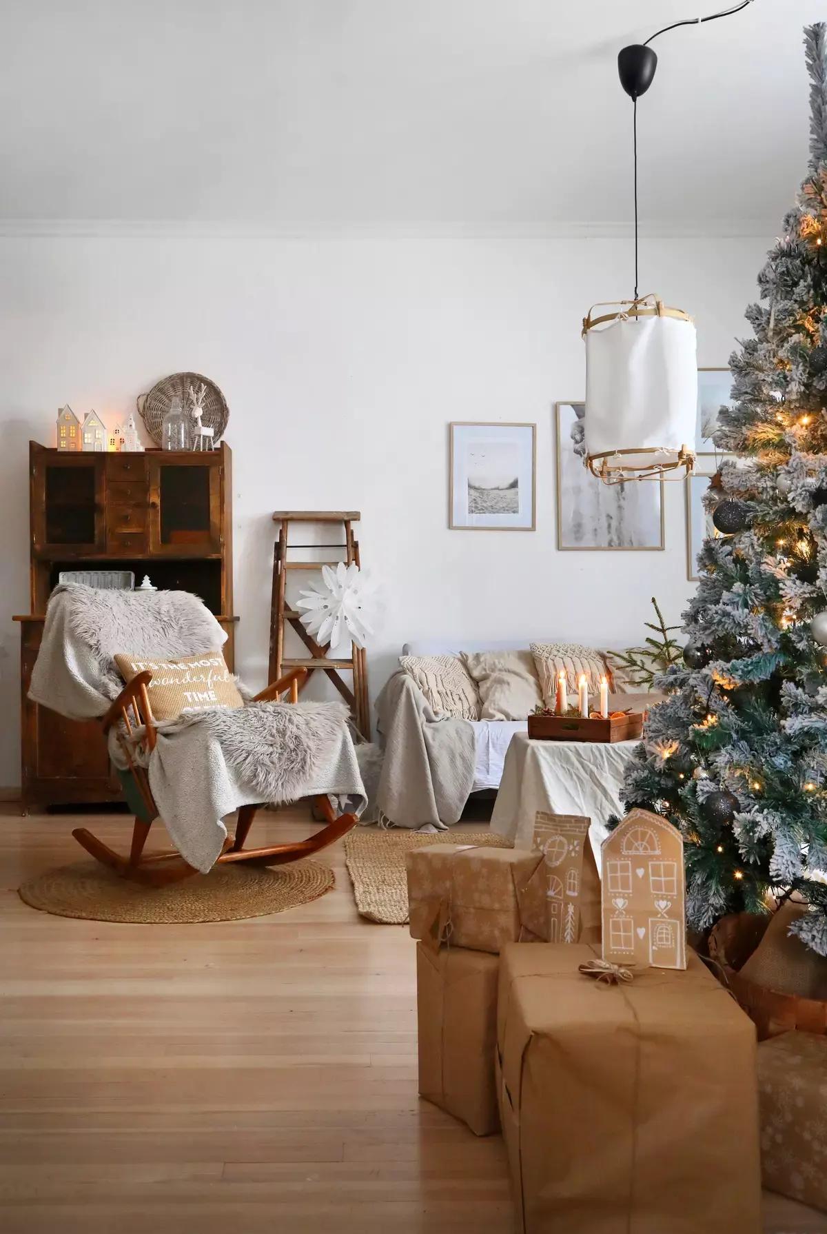 Contemporary living room with a snow-flocked tree and kraft-wrapped presents