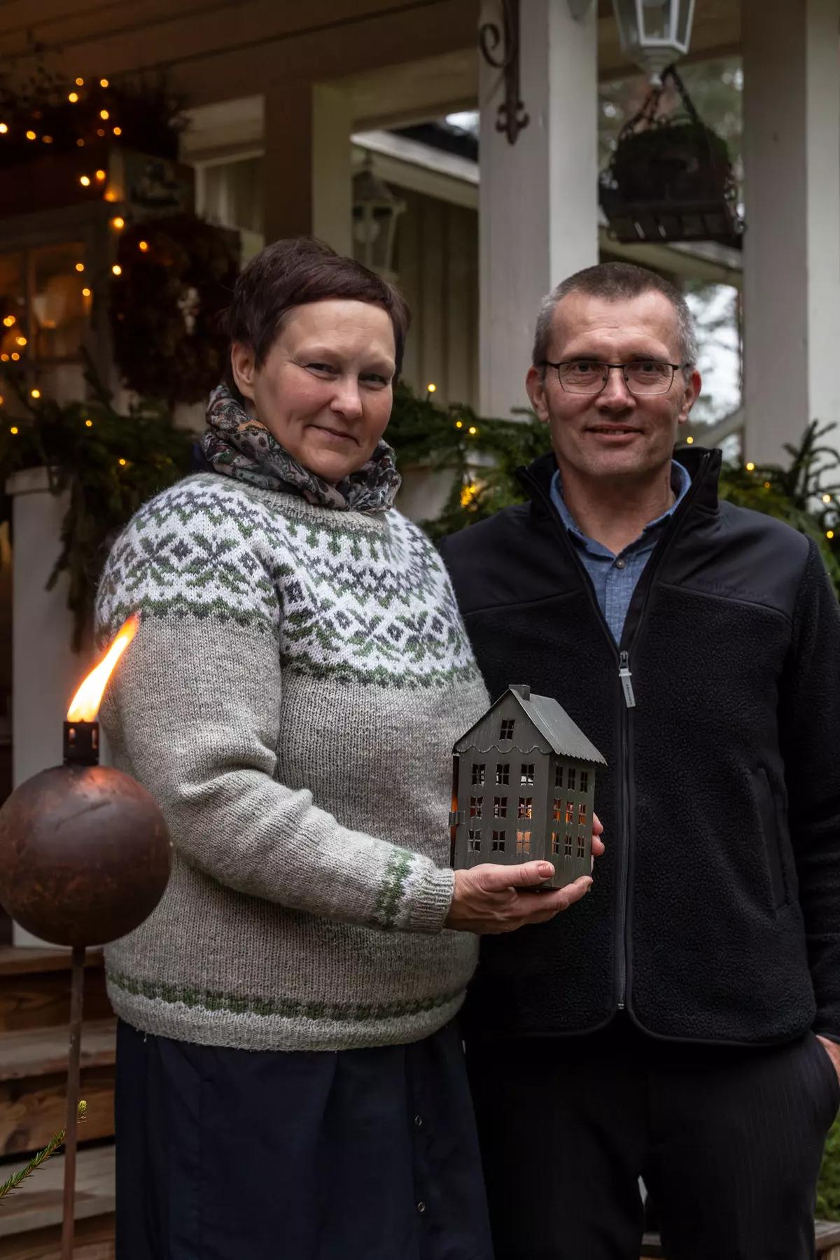 Finnish couple on the porch of their home with holiday decorations
