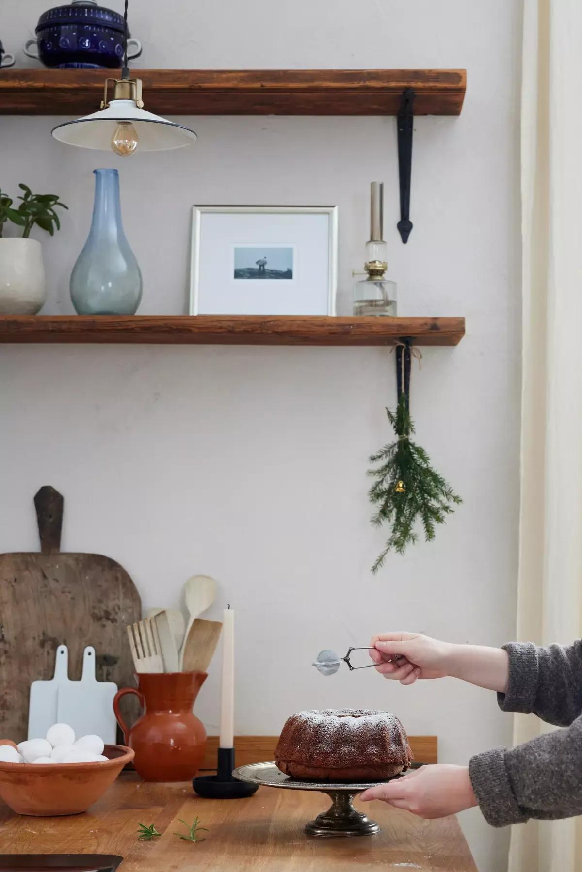 Hands dusting freshly baked pastries with powdered sugar