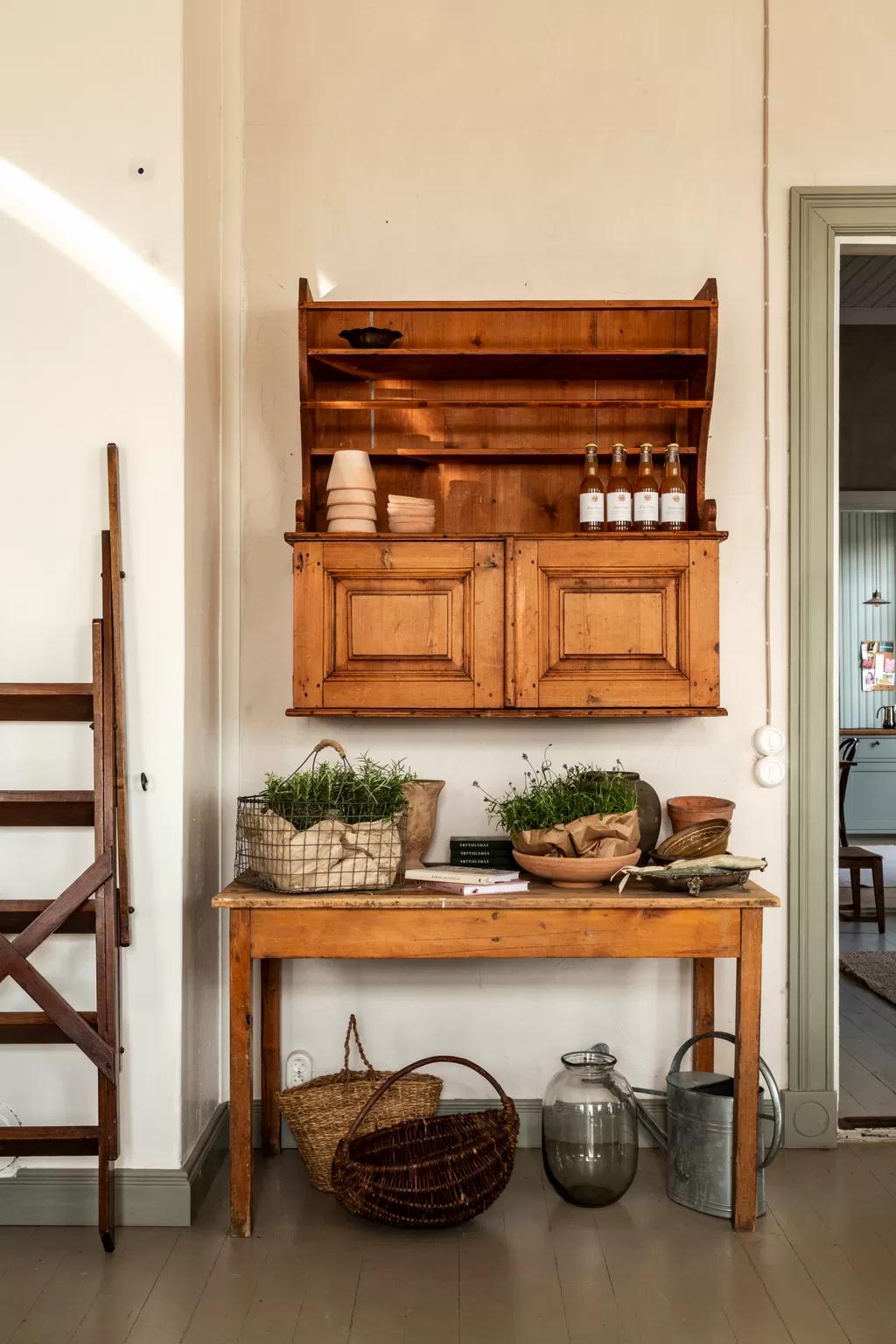 Wooden table arranged with baskets and potted plants