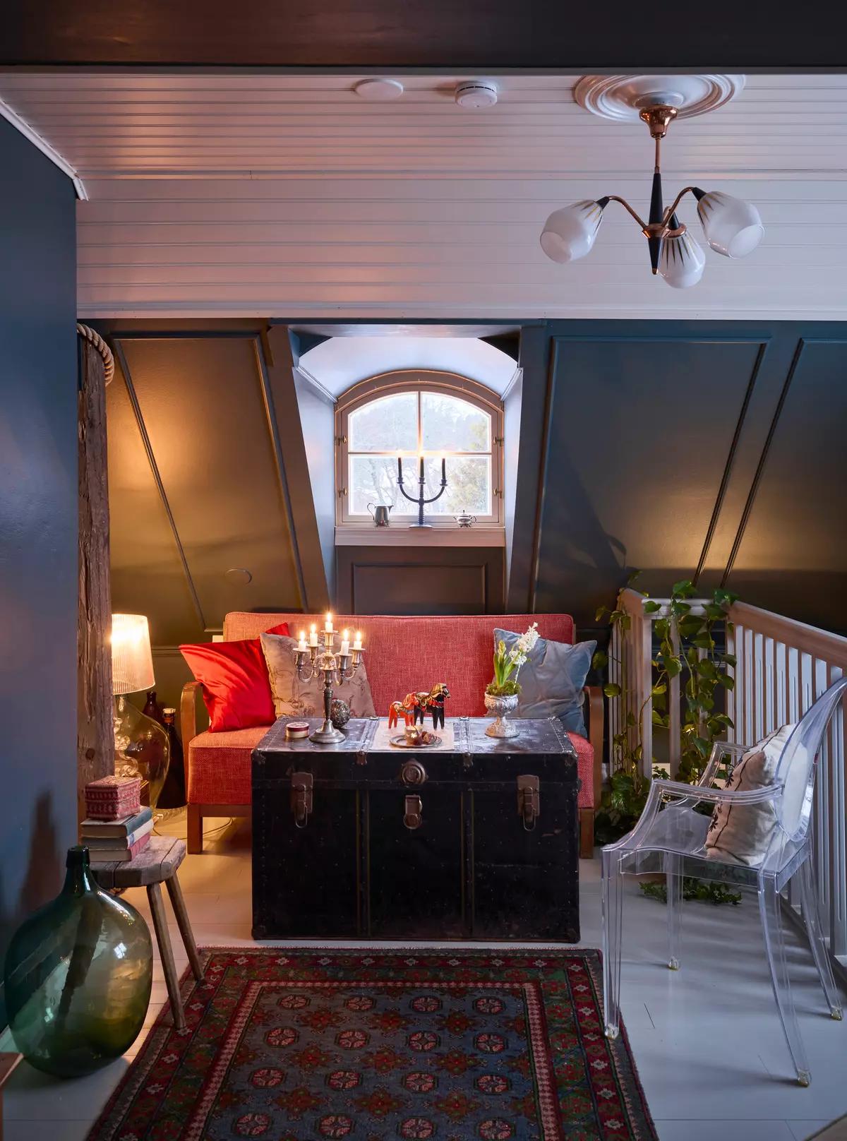 Sofa and an antique black trunk used as a table on the second-floor landing