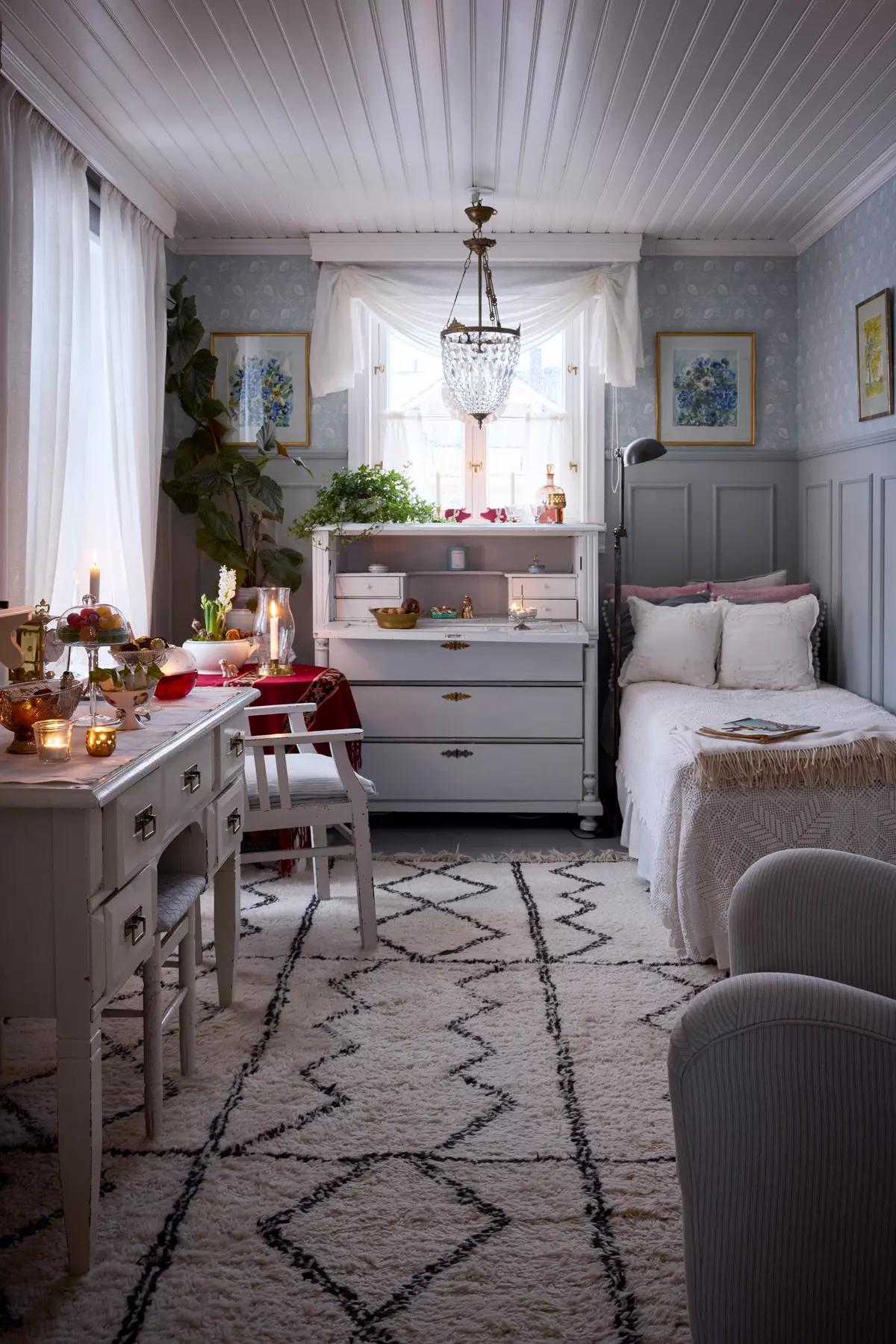 Modest Finnish bedroom with a single bed and distressed furniture