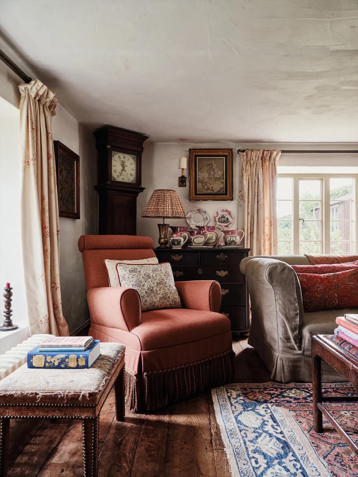 Living room with vintage furniture, mantel clock and dishes on a dresser