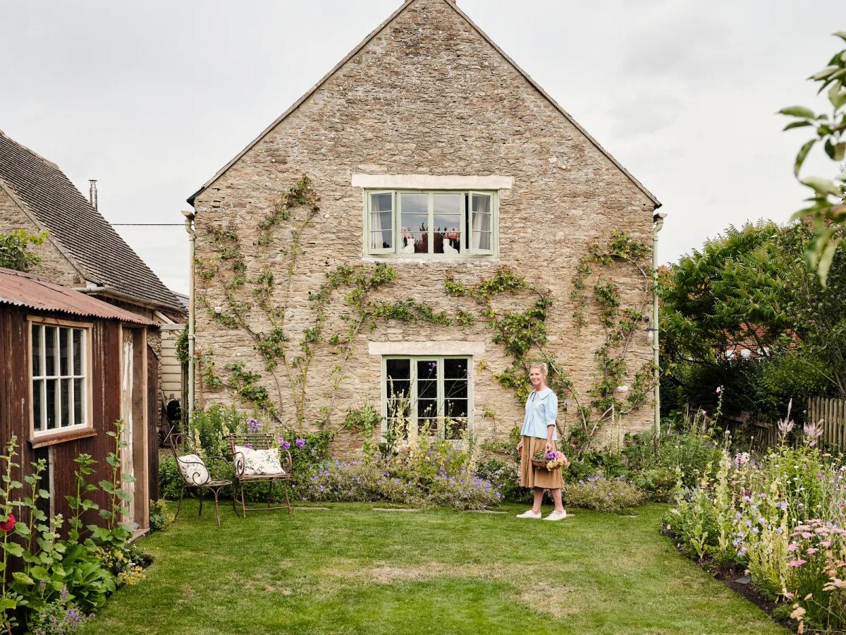 Alexandra Tolstoy standing in front of her Cotswold cottage