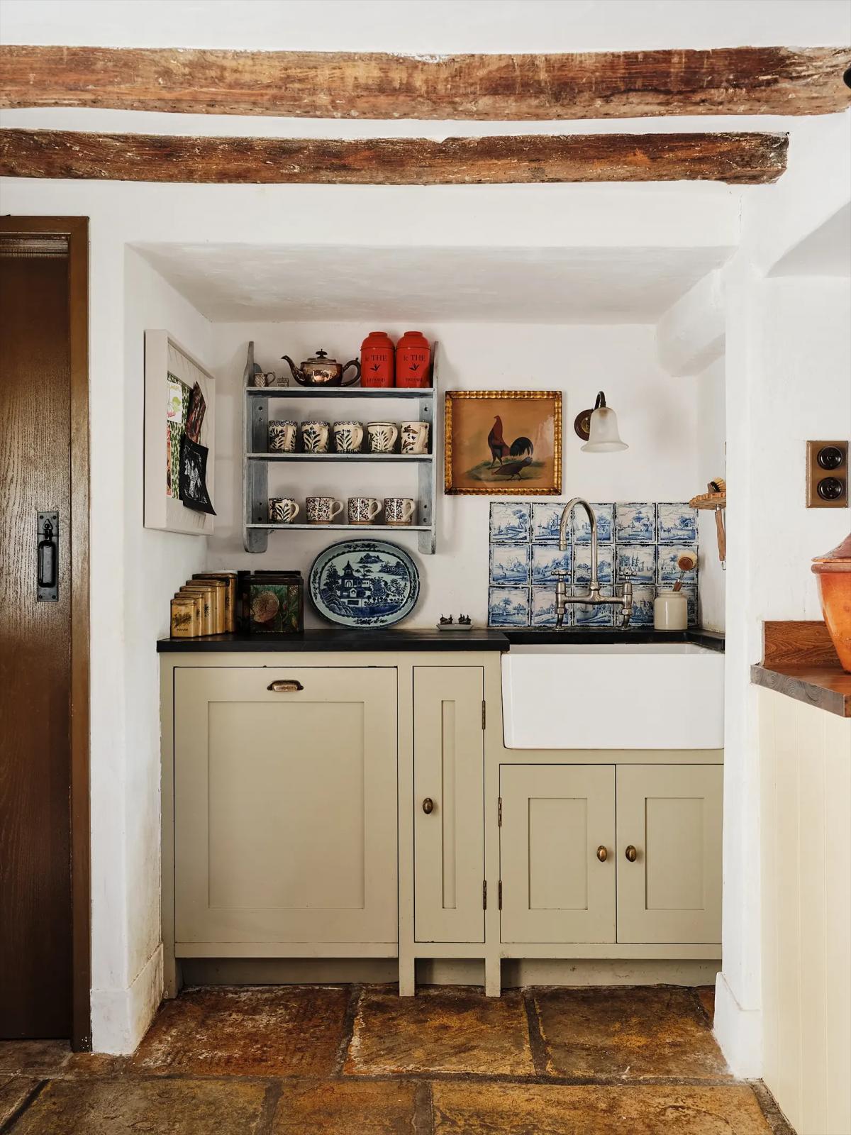 Country-style kitchen with cream cabinets and stone floor