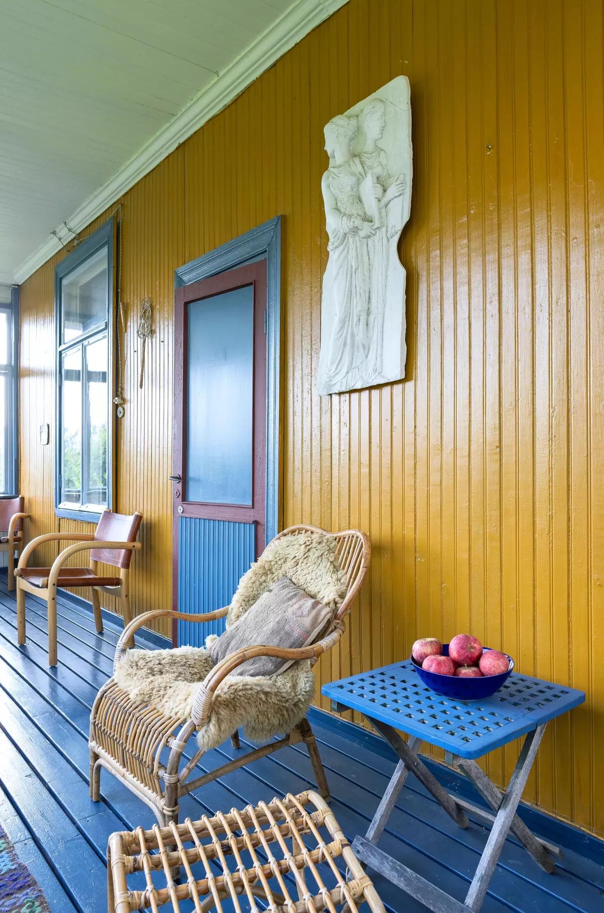 Blue painted floor on the veranda of the yellow house