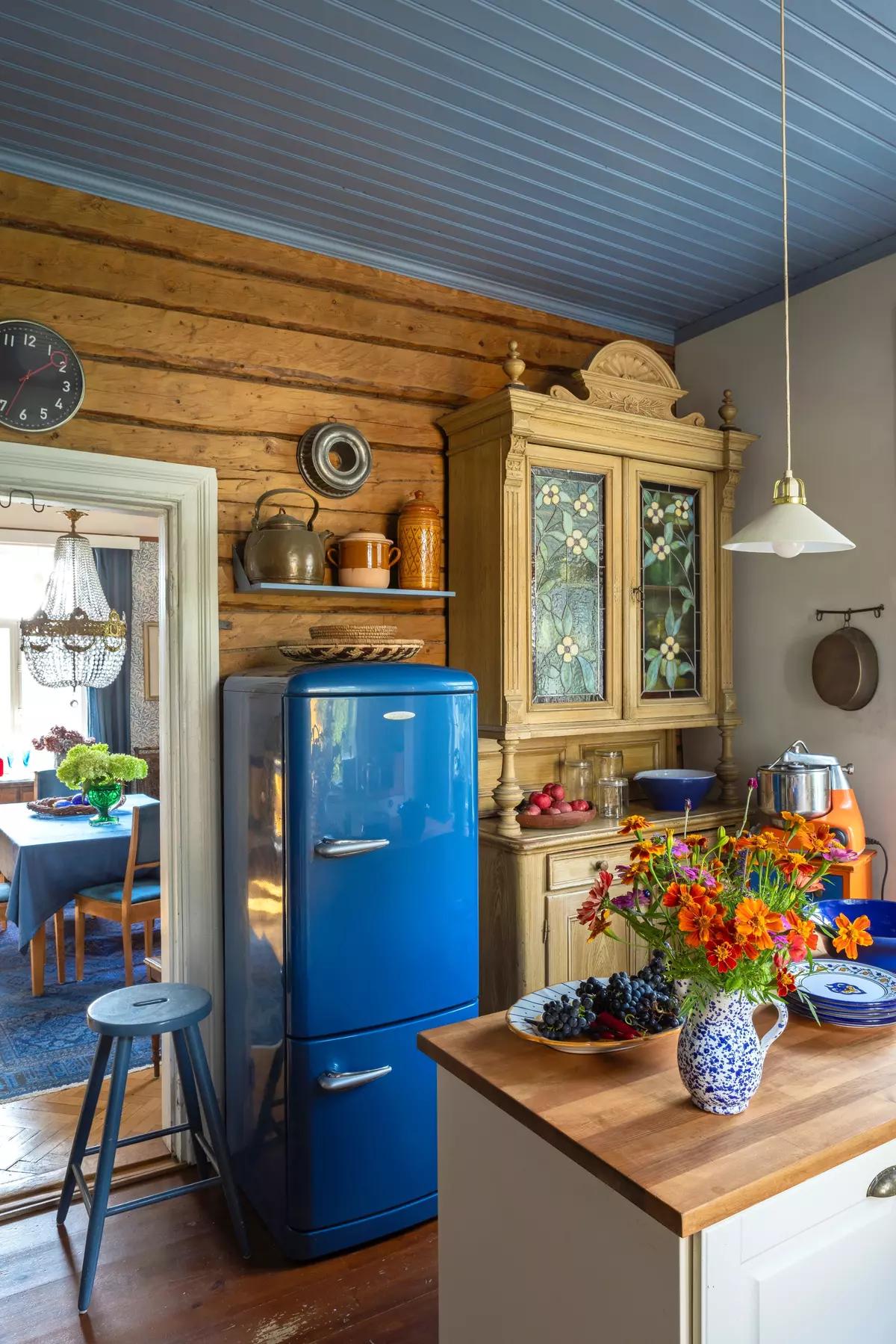 Blue farmhouse fridge in the kitchen, bouquet on the island